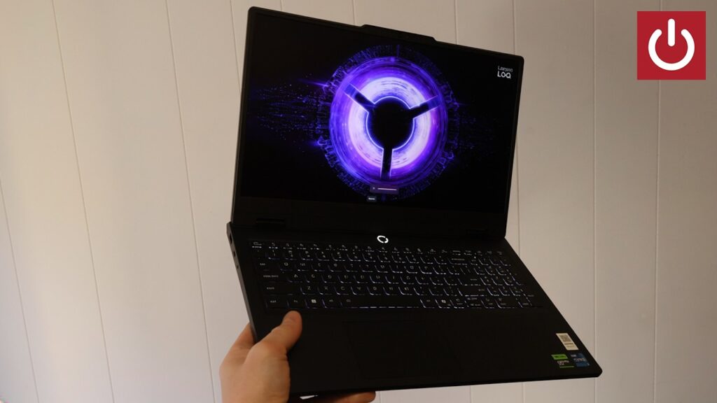 A student using the Lenovo LOQ Essential 15 gaming laptop in a cafe setting.